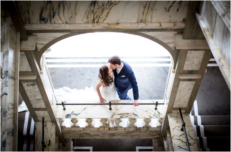 bride and groom on marble stairs at rosewood hotel wedding