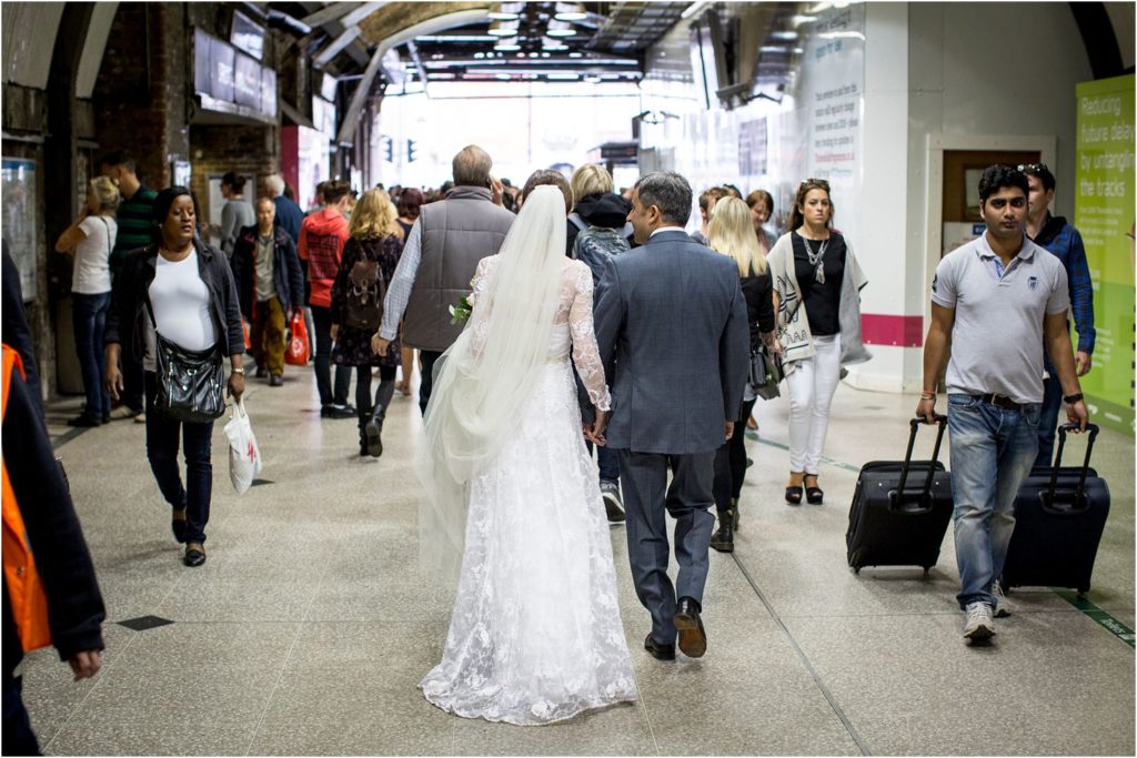 bride and groom walking through Tower Bridge Station